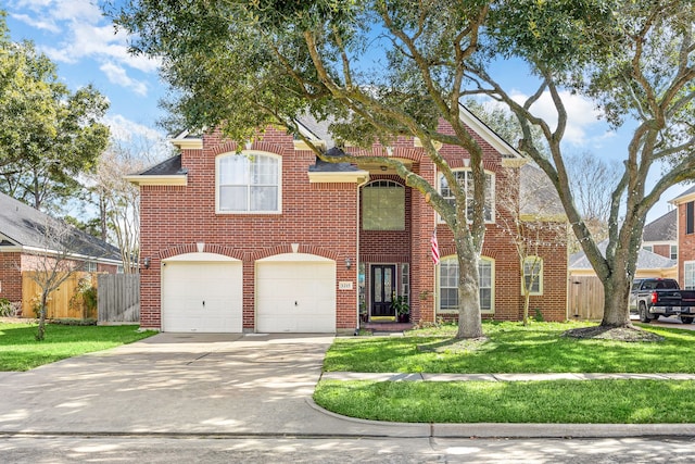 traditional-style home with driveway, a front yard, fence, and brick siding