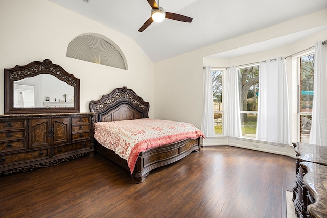 bedroom with multiple windows, vaulted ceiling, and hardwood / wood-style floors