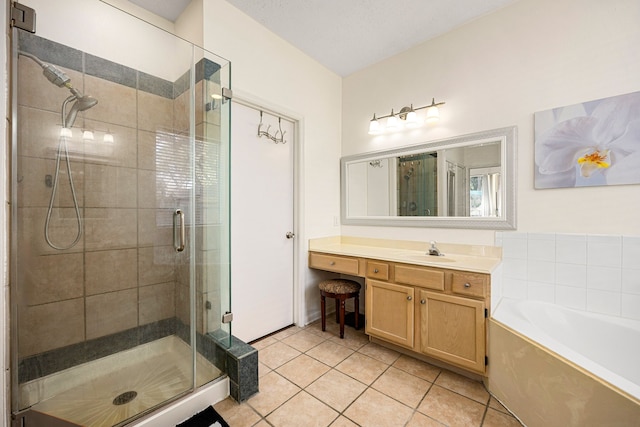 full bath featuring a stall shower, vanity, a bath, and tile patterned floors