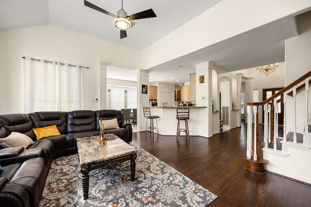 living area featuring stairs, dark wood-style flooring, decorative columns, and a ceiling fan