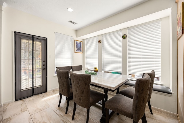 dining room with recessed lighting, marble finish floor, visible vents, and baseboards