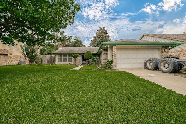 view of front of home featuring brick siding, a chimney, an attached garage, a front yard, and driveway