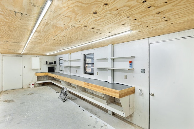 interior space with wooden ceiling and a workshop area