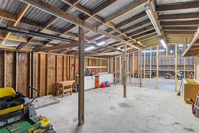 miscellaneous room featuring vaulted ceiling and concrete flooring