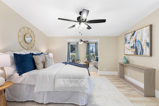 bedroom with light wood-type flooring, ceiling fan, and baseboards