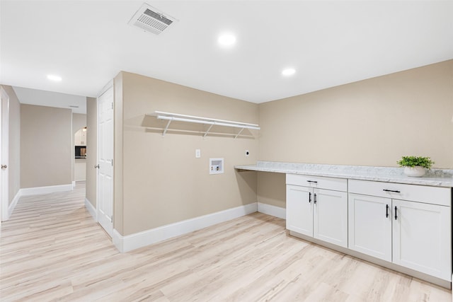 clothes washing area featuring washer hookup, visible vents, hookup for an electric dryer, and light wood-style flooring