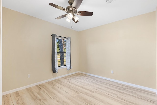 unfurnished room featuring light wood-style floors, ceiling fan, visible vents, and baseboards