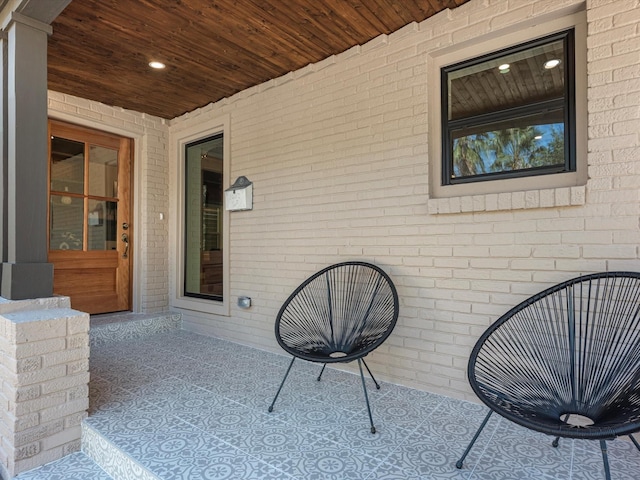 doorway to property with brick siding