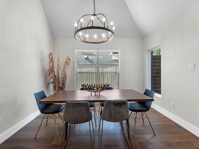 dining room with dark wood-style floors, baseboards, vaulted ceiling, and a notable chandelier