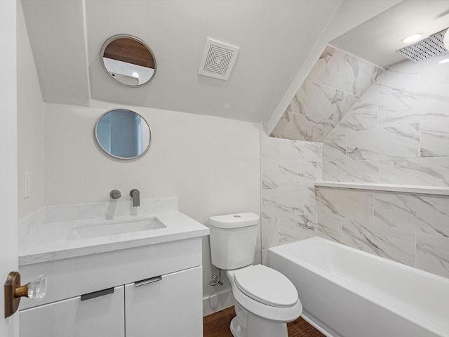 bathroom with visible vents, toilet, vanity, wood finished floors, and  shower combination