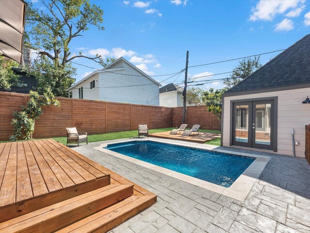 view of pool featuring a fenced in pool, a patio area, a fenced backyard, and french doors