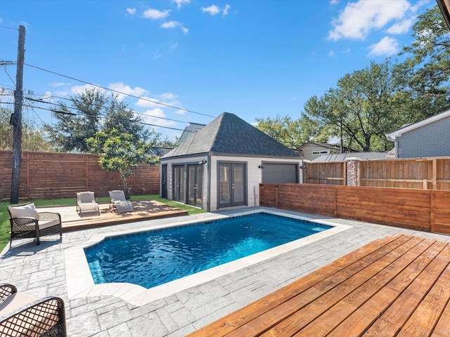 view of pool featuring a patio, a storage structure, an outdoor structure, and a fenced backyard