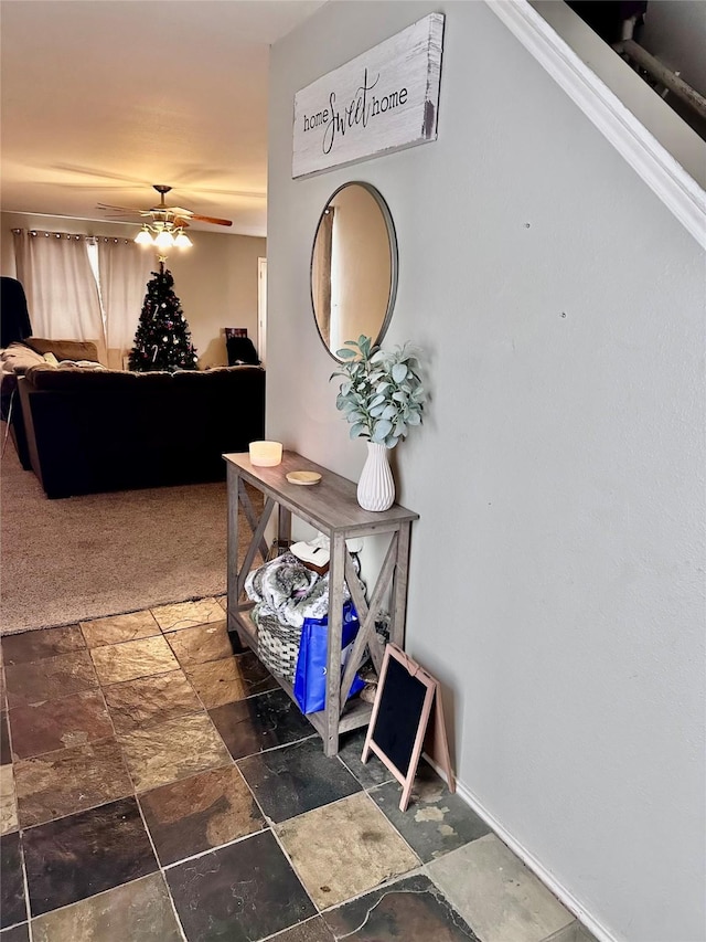 interior space with stone tile flooring and baseboards