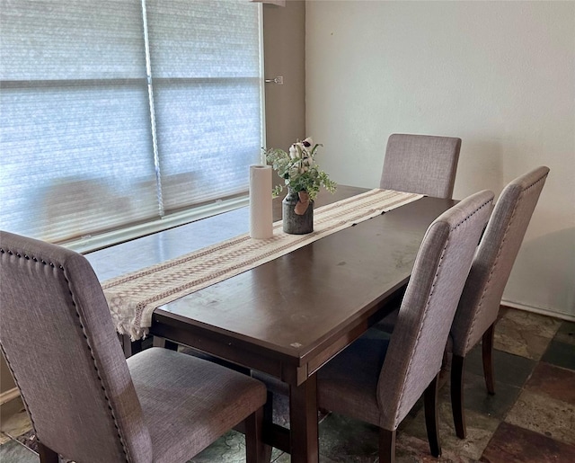 dining room with stone tile flooring