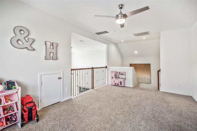 rec room featuring carpet floors, visible vents, a ceiling fan, and lofted ceiling