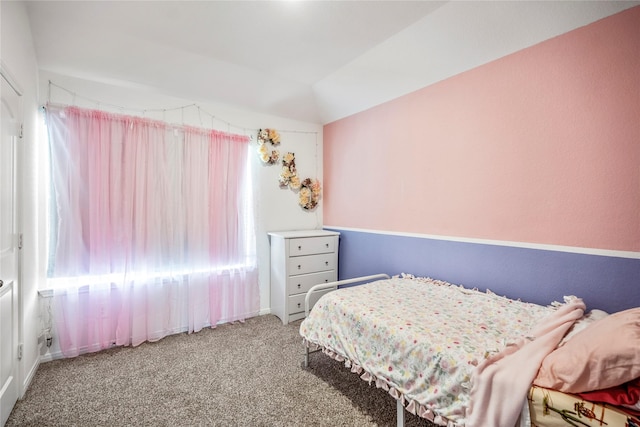 carpeted bedroom with vaulted ceiling