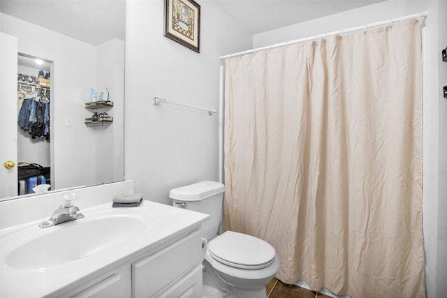 full bath featuring vanity and toilet