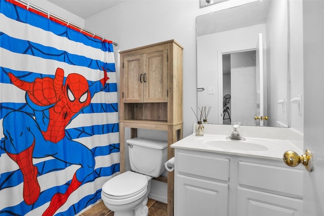 bathroom featuring toilet, curtained shower, tile patterned flooring, and vanity