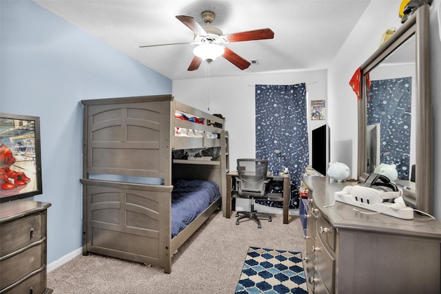 bedroom featuring light carpet, baseboards, and a ceiling fan