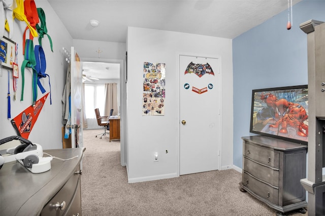 bedroom with baseboards and light colored carpet