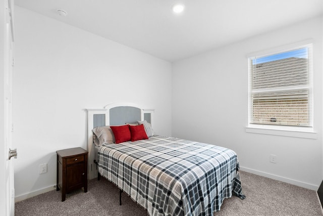 carpeted bedroom featuring baseboards