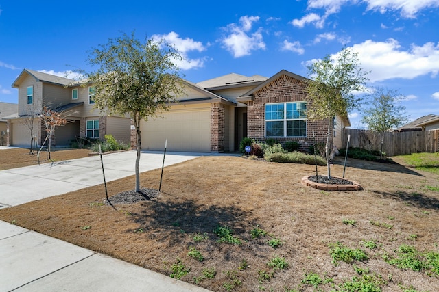 single story home featuring brick siding, fence, driveway, and an attached garage