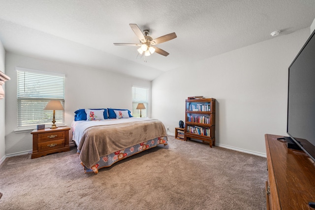 bedroom featuring a textured ceiling, a ceiling fan, baseboards, vaulted ceiling, and carpet