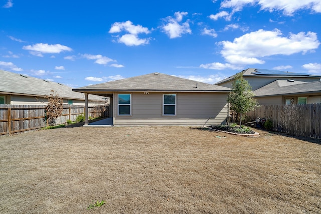 back of property featuring a fenced backyard and a patio