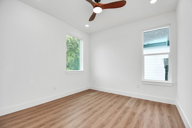 spare room with light wood finished floors, ceiling fan, baseboards, and recessed lighting