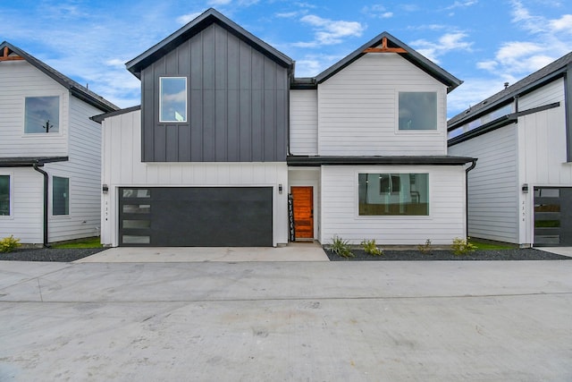 view of front of property with a garage, driveway, and board and batten siding