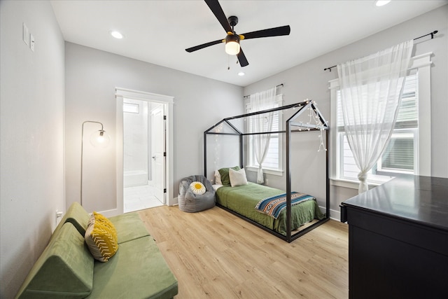 bedroom with baseboards, connected bathroom, light wood-style flooring, ceiling fan, and recessed lighting