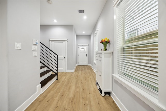 interior space with baseboards, visible vents, stairs, light wood-type flooring, and recessed lighting