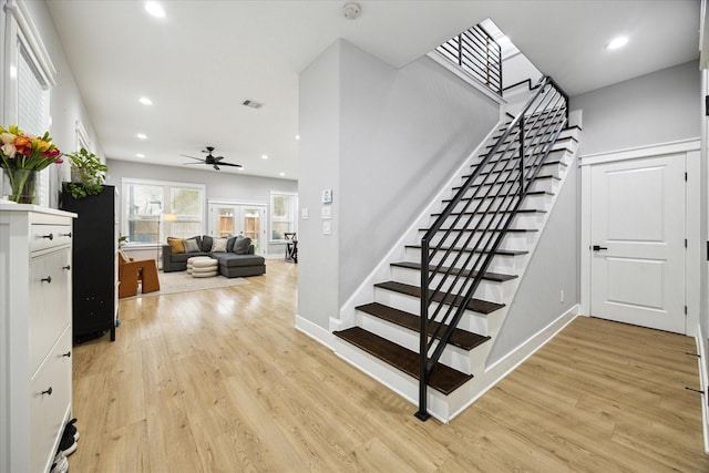 stairs featuring baseboards, visible vents, wood finished floors, and recessed lighting