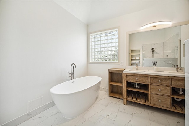 bathroom featuring marble finish floor, a soaking tub, vaulted ceiling, a sink, and a walk in shower