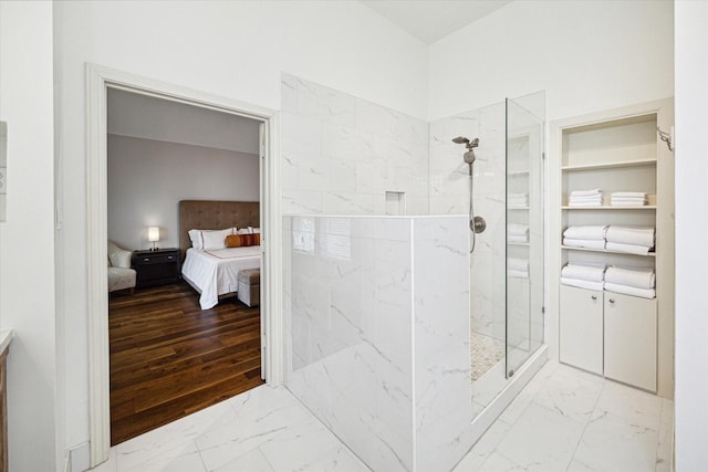 full bath featuring ensuite bathroom, marble finish floor, and walk in shower