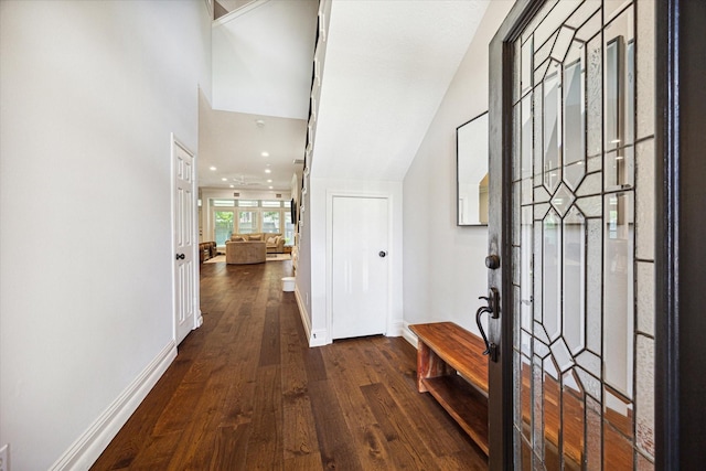 entryway with dark wood-style flooring and baseboards