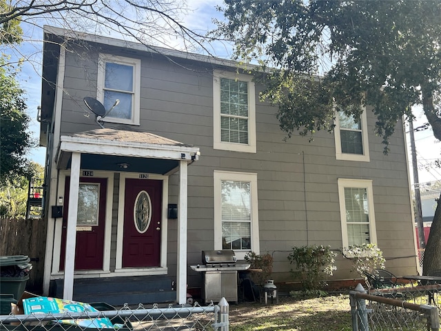 view of front of property featuring fence