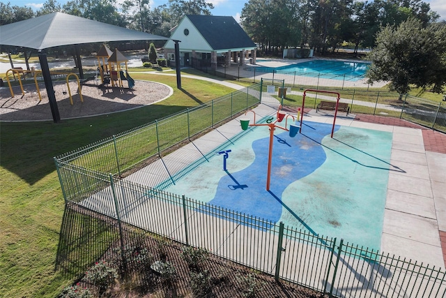 view of property's community with playground community, a yard, a gazebo, and fence