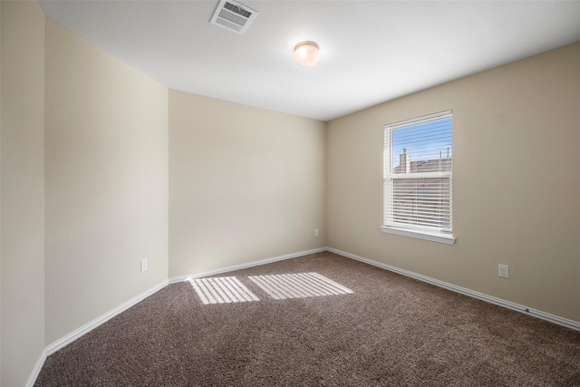 carpeted spare room with baseboards and visible vents