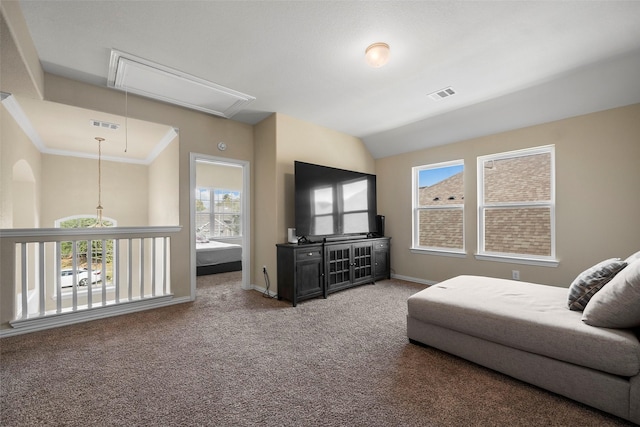 living room with lofted ceiling, carpet, visible vents, and attic access