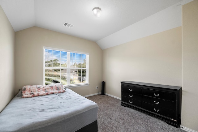 bedroom featuring baseboards, visible vents, vaulted ceiling, and light colored carpet