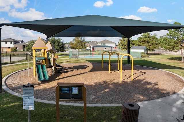 community playground with fence and a lawn