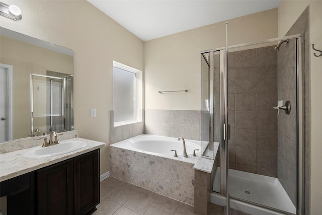 bathroom with tile patterned flooring, a garden tub, a shower stall, and vanity