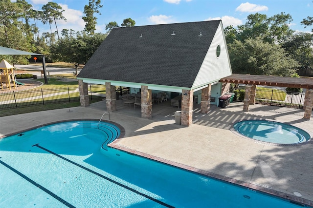 view of swimming pool featuring a fenced in pool, a patio, exterior bar, and fence