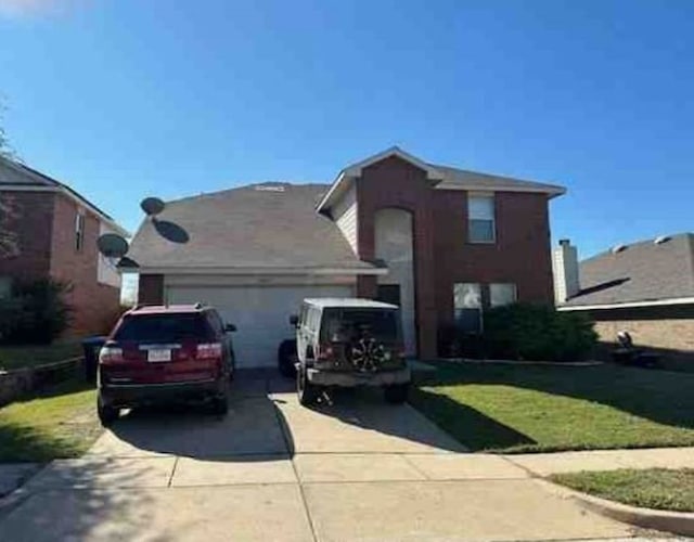 traditional-style home featuring a garage, driveway, and a front lawn