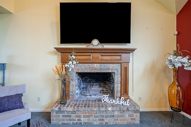 room details featuring carpet floors, a fireplace, and baseboards