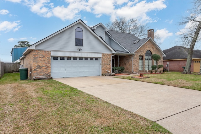 view of front facade with concrete driveway, a front lawn, a chimney, and brick siding