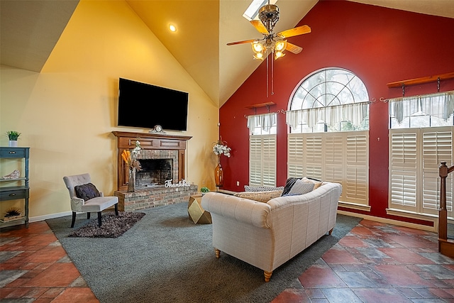 living area with high vaulted ceiling, stone tile flooring, and a fireplace