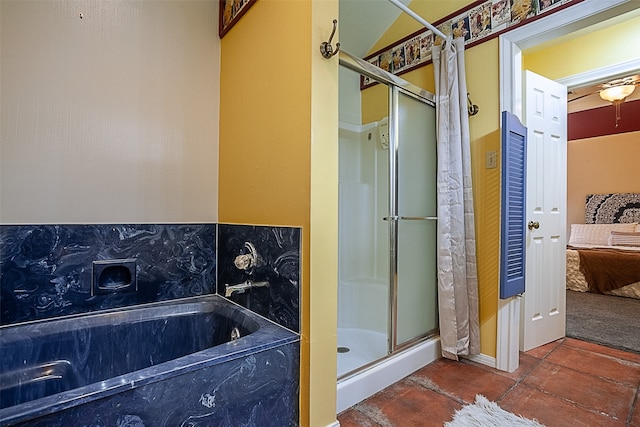 bathroom with a stall shower and a garden tub