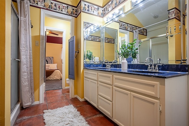 ensuite bathroom featuring double vanity, a shower with door, a sink, and ensuite bathroom